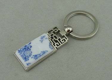 Κράμα ψευδάργυρου 1.5 ίντσας που διαφημίζει Keychains με το κομμάτι πορσελάνης που παρεμβάλλεται