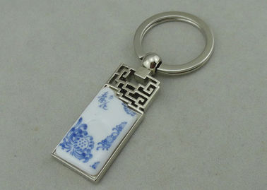 Κράμα ψευδάργυρου 1.5 ίντσας που διαφημίζει Keychains με το κομμάτι πορσελάνης που παρεμβάλλεται